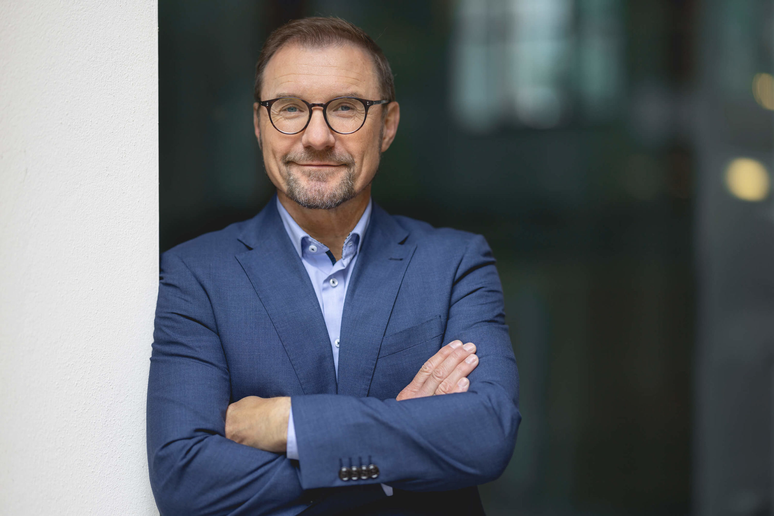 Oliver_Lindloff HERATAX Steuerberater Partner Oliver Lindloff HERATAX Steuerberatung Partner Portrait verschränkte Arme draußen, leihctes Lächeln, vertrauensvoll, seriös